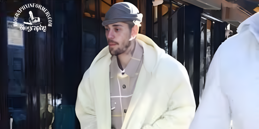 A man in a white coat and hat walking along the street, associated with Justin Bieber collaborations